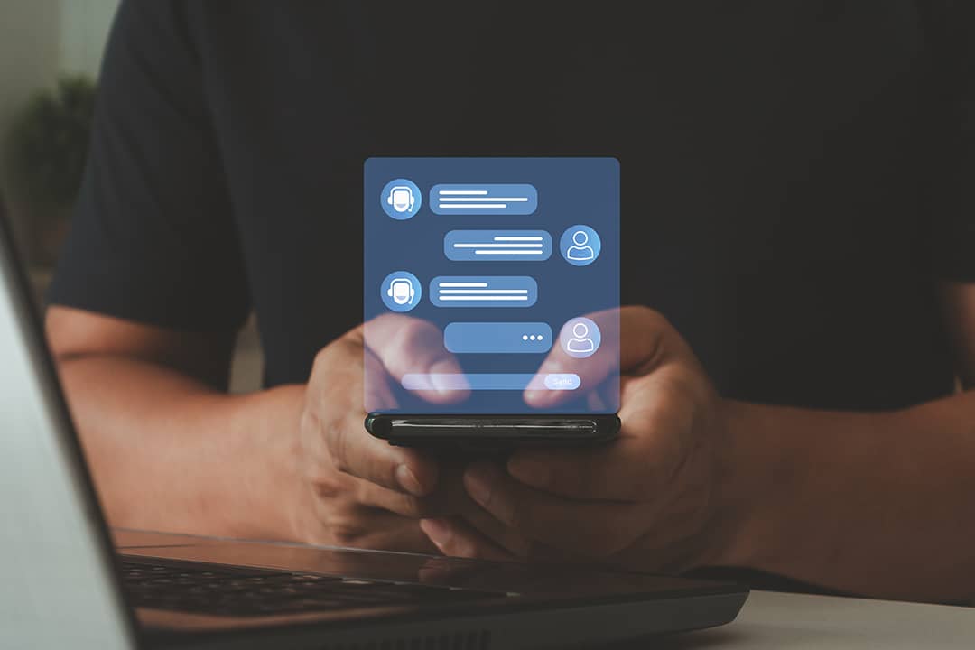A person using a smartphone with a holographic AI-driven chatbot messaging interface for services concerns.